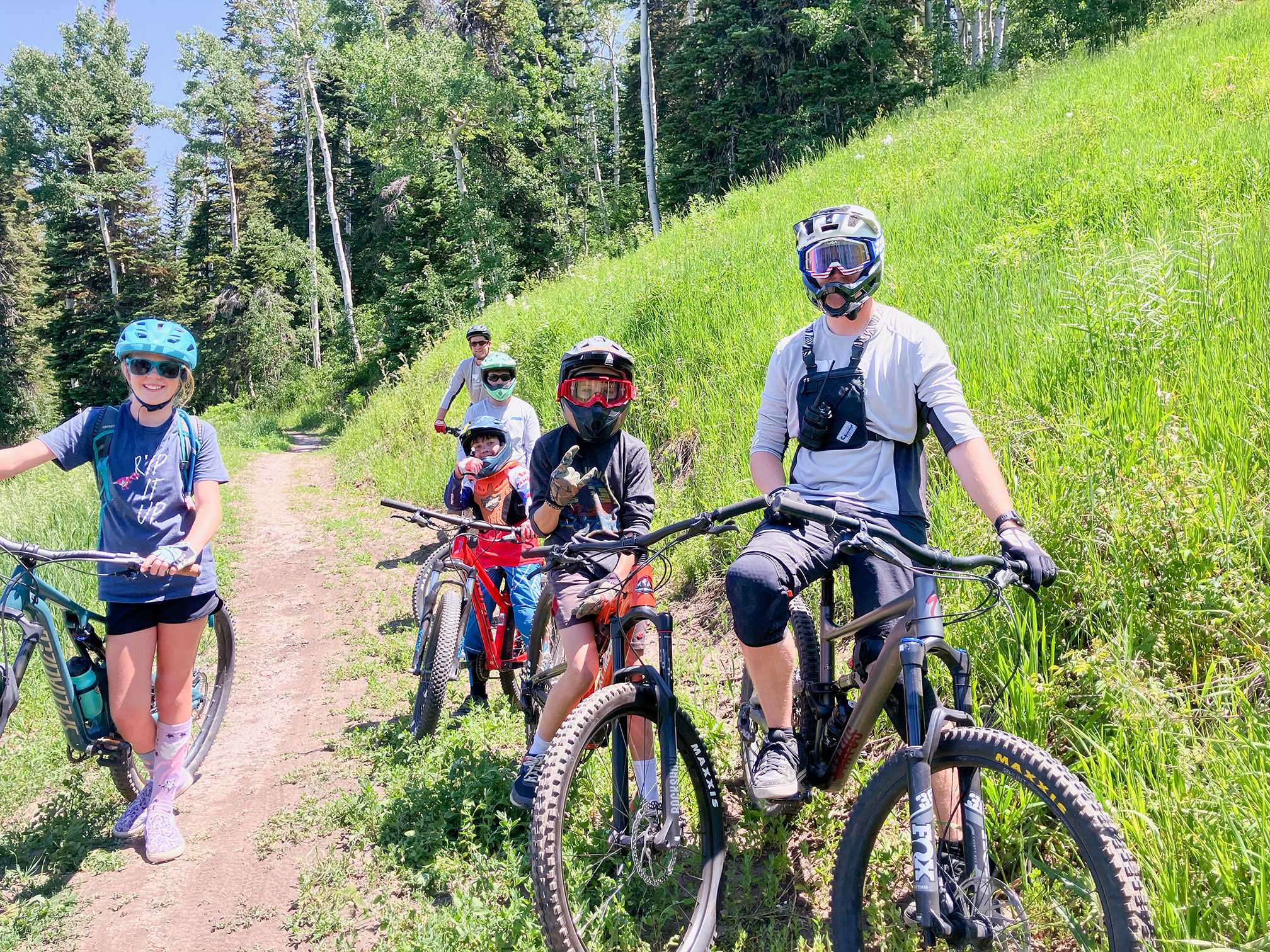 young bike rider with adult following